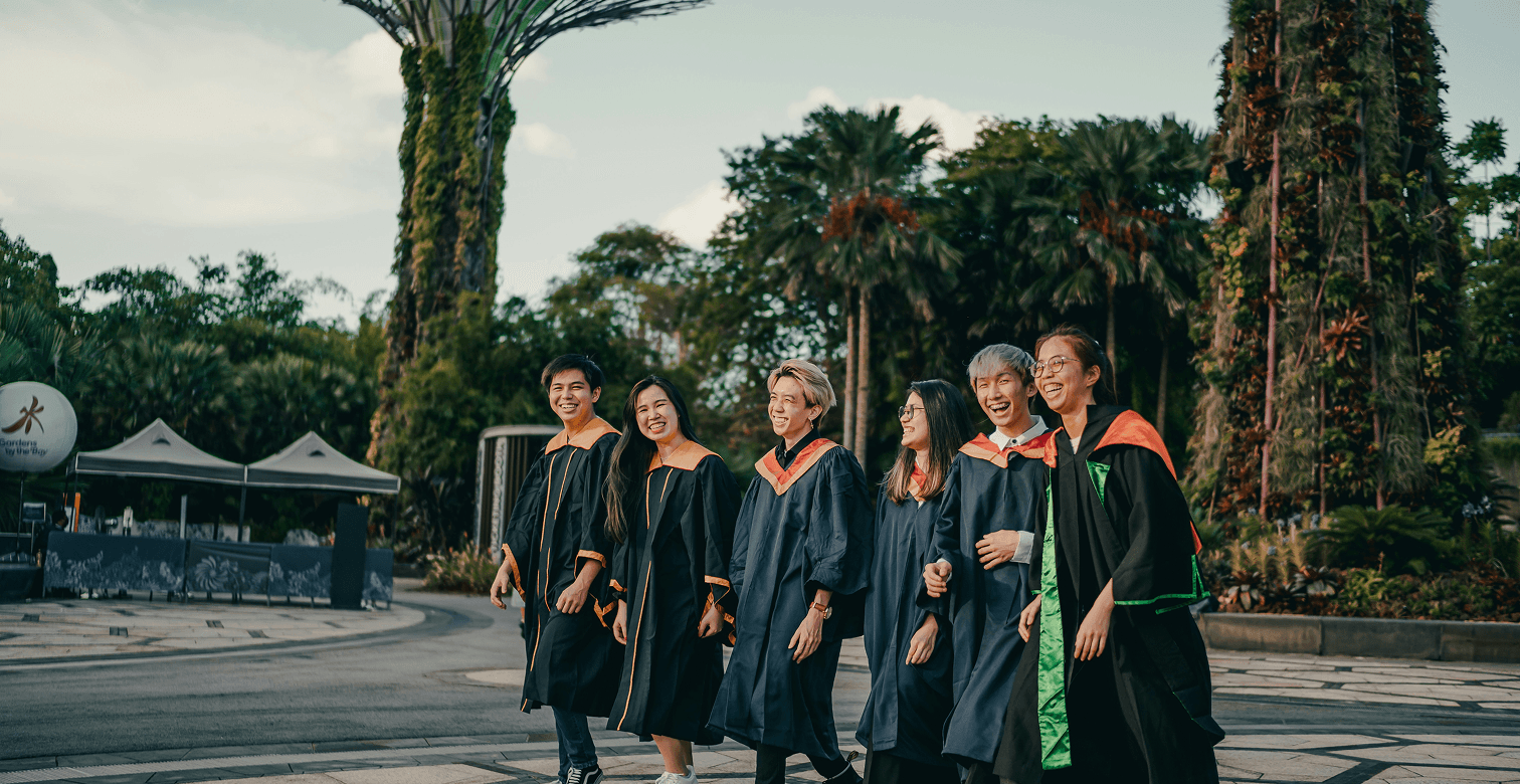 Students in graduation gowns on Acropolis campus